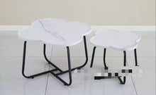 Load image into Gallery viewer, Two white stools with black metal legs on a light-colored floor.
