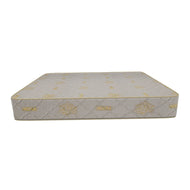 This is an image of the Mouka Semi Orthopedic Mattress, showing a top view of the mattress with floral patterns embossed on its surface. The mattress appears to be white with gold accents, and it is designed for a comfortable night's sleep.