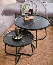 Load image into Gallery viewer, Black marble-patterned coffee table with decorative items in a living room setting.
